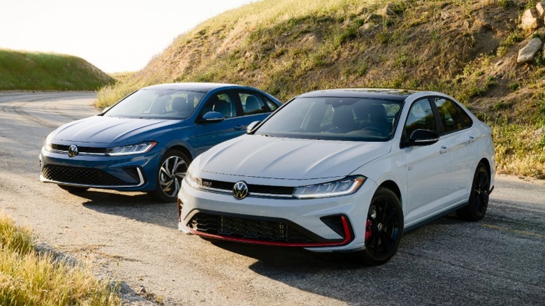 Blue Volkswagen Jetta and gray Volkswagen Jetta GLI parked on a rural road
