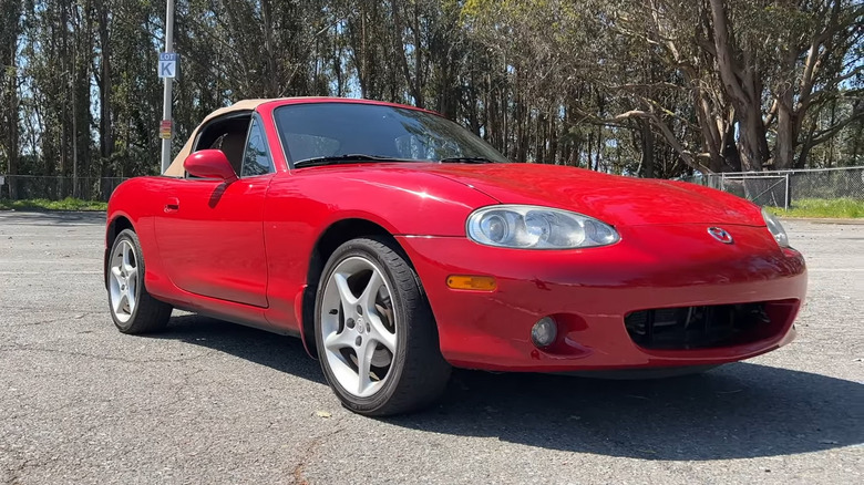 A front end shot of a red 2002 Mazda MX-5