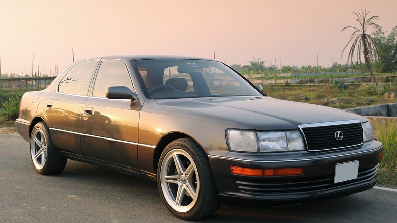 Black Lexus LS 400 with aftermarket wheels parked on asphalt
