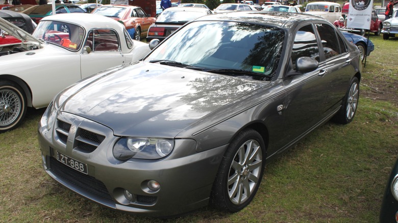 Gray MG ZT 260 parked on grass at a car show