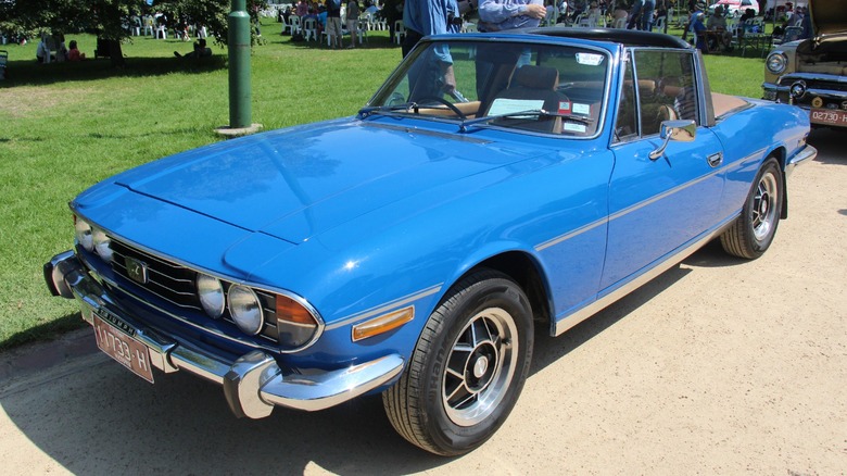 Blue Triumph Stag parked at roadside