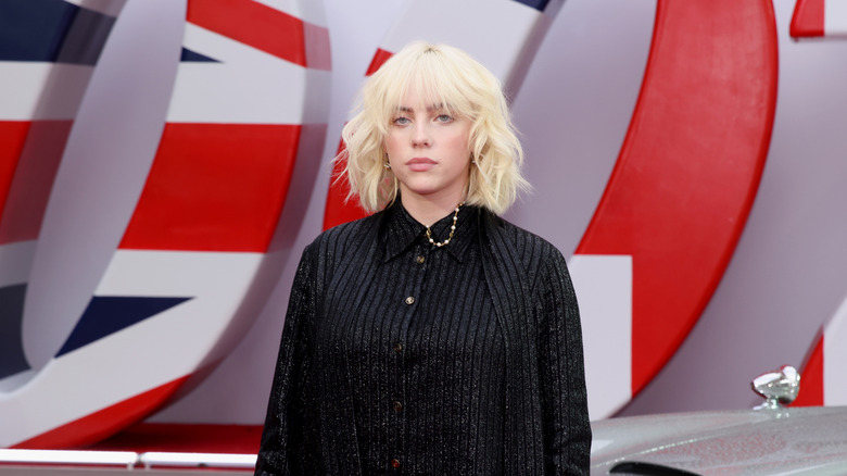 Billie Eilish standing on stage