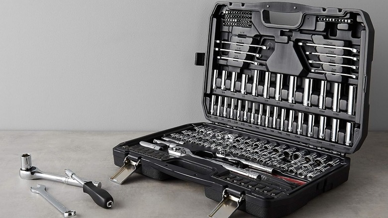 open tool case with tools inside and nearby