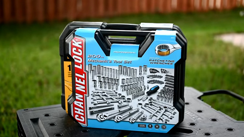 an unopened tool set on a table in a backyard