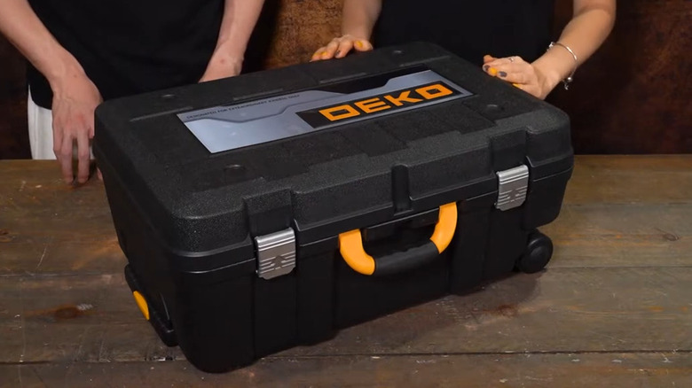 a large black plastic case with yellow handle