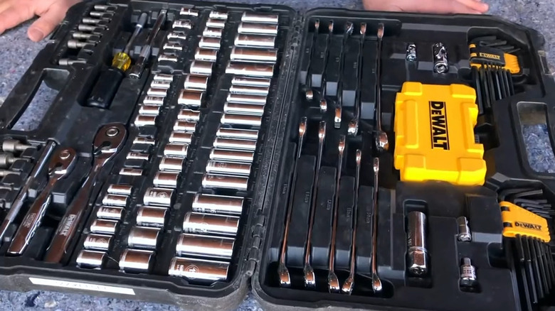 Open tool case with sockets and tools