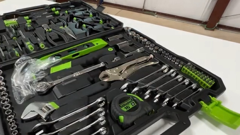 Open tool case with silver and green tools inside