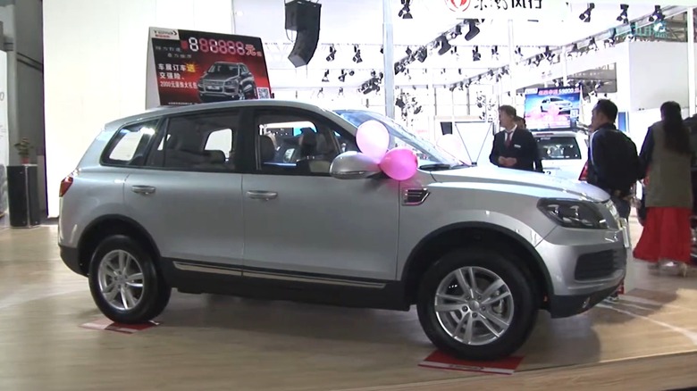 A silver Yema T70 festooned with balloons at an indoor display