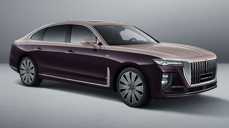 A burgundy and gold two tone Hongqi H9 against a studio background