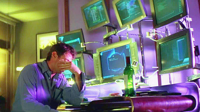 Hugh Jackman looking tired after hacking using seven monitors