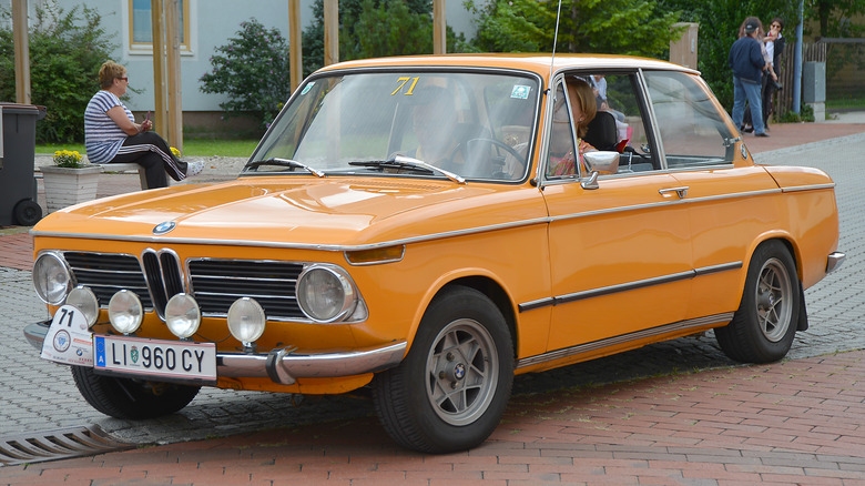 Orange BMW 2002 on the road