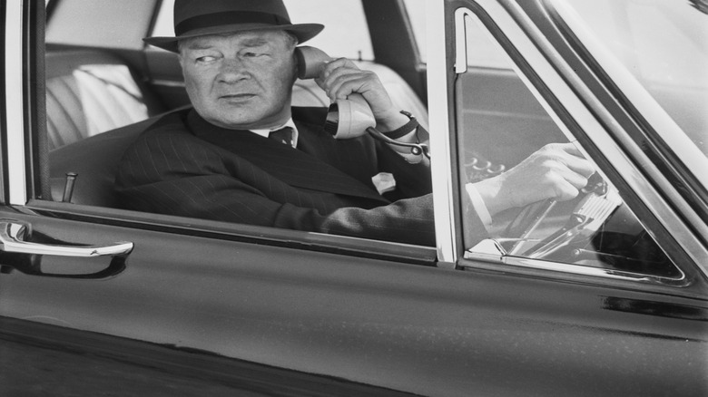 Man on hard-wired car telephone