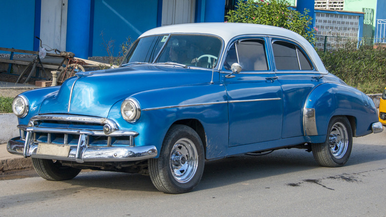 vintage blue car parked at curbside