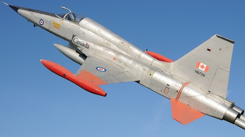 Canadian fighter plane climbing in a blue sky