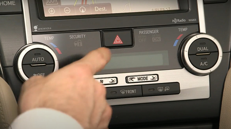 Man presses hazard light button