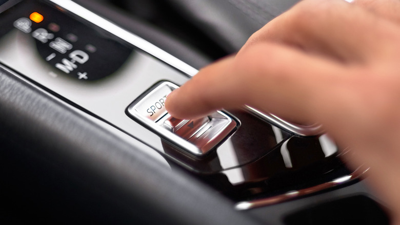 Finger pressing sport mode closeup