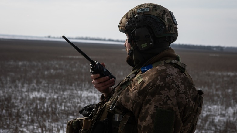 a soldier talking on the radio