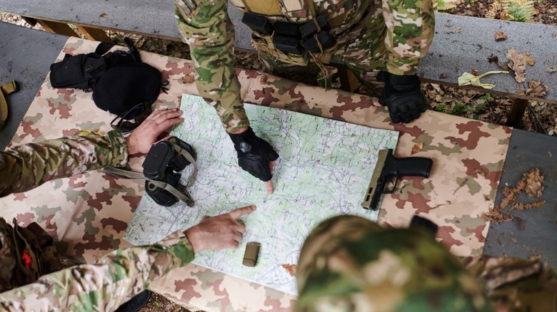 soldiers looking at a map and making plans