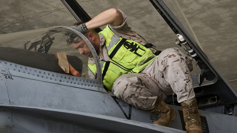 an air force mechanic working on a plane
