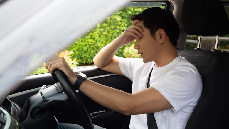 Car owner regretting his poor maintenance routine