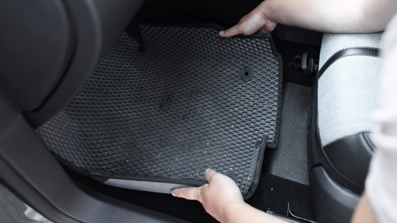 technician checking the fit of a floor mat
