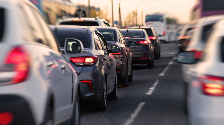 cars stopped in traffic with brake lights illuminated
