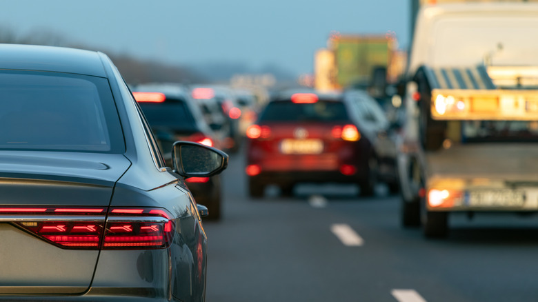 red car changing lanes in high traffic