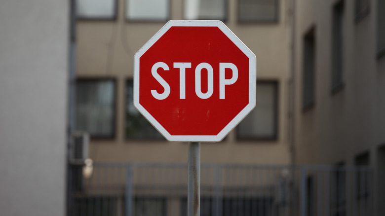 a stop sign in front of a residential apartment building
