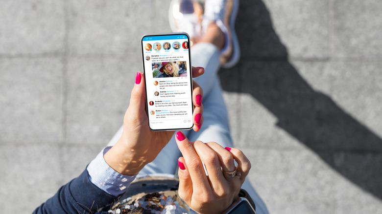 woman browsing Twitter timeline on smartphone