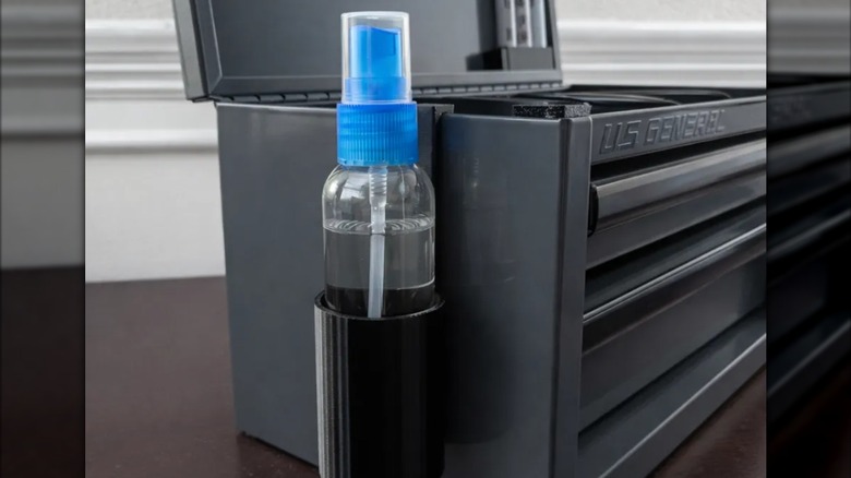 a 3D-printed spray bottle holder hanging on the side of the Harbor Freight Mini Toolbox