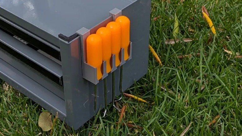 a 3D-printed toolbox pick holder hanging on the side of the Harbor Freight Mini Toolbox