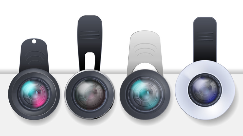 Photorealistic camera lenses hanging on a thread by clip-on