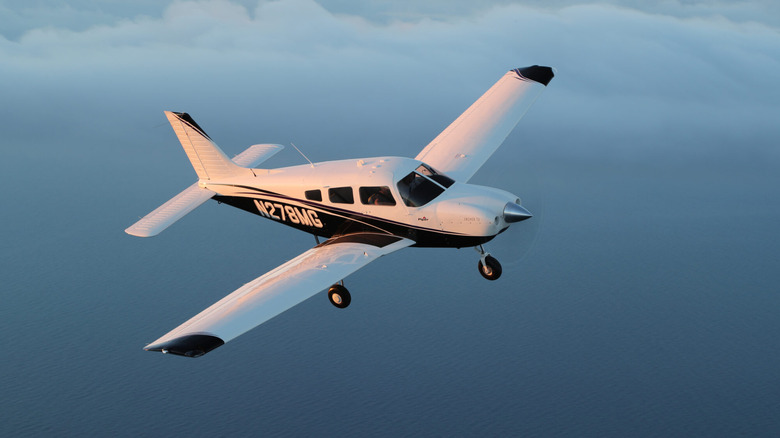 A Piper airplane soaring through the sky.