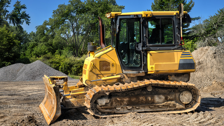 A yellow bulldozer on a construction site.