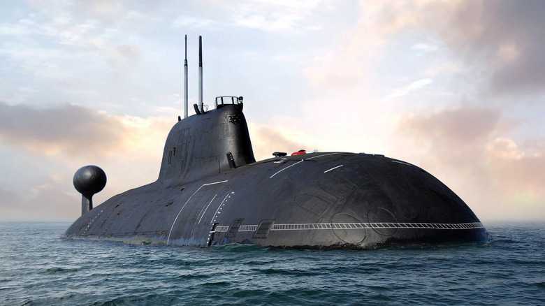 A black naval submarine surfacing from the depths of the sea.
