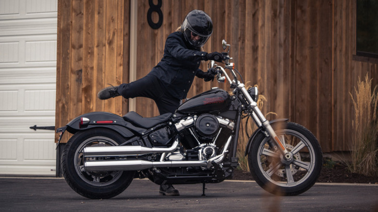 A 2024 Harley-Davidson Softail Standard being mounted by a rider in full gear