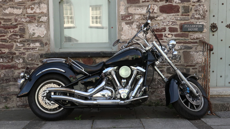 A Yamaha XV1600 Road Star parked in a rustic spot in an english town