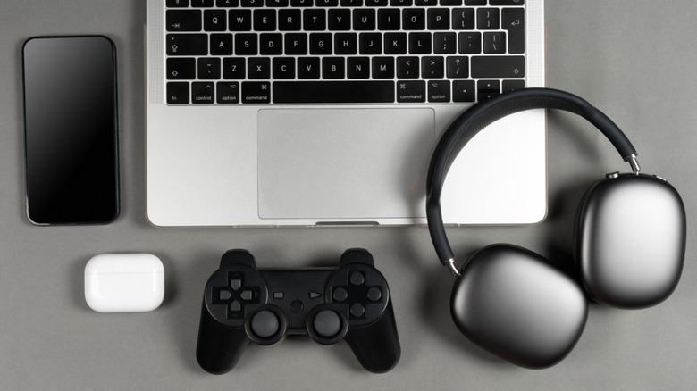 a picture of laptop, phone, headphones, etc. on desk