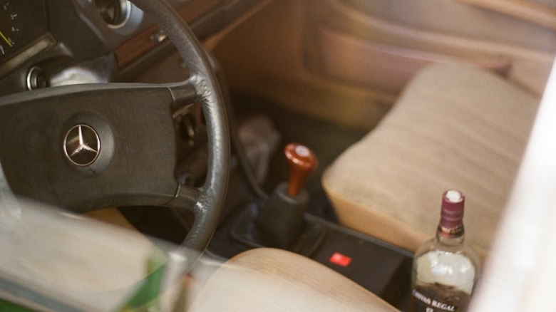 The interior of a Mercedes, a bottle of alcohol and the old feel.