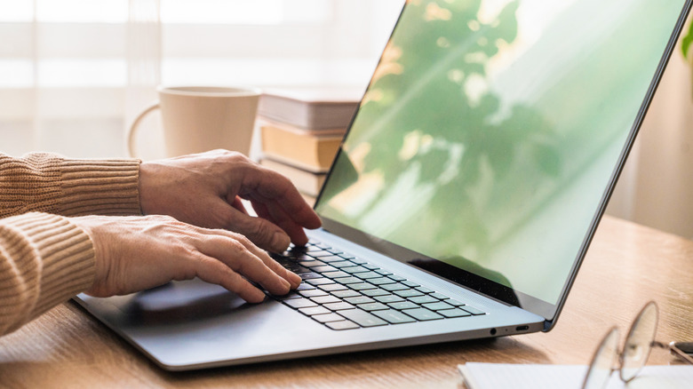 A person typing on a computer