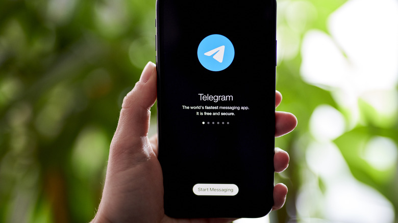 Telegram app on smartphone held in hand