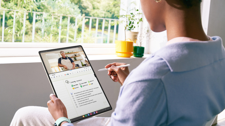 A woman uses the Samsung Galaxy Tab S9 Ultra