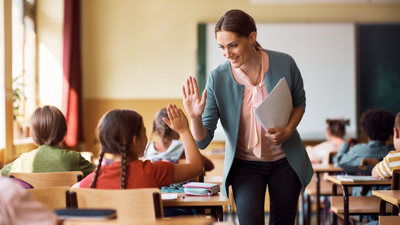 Teacher high-fiving student