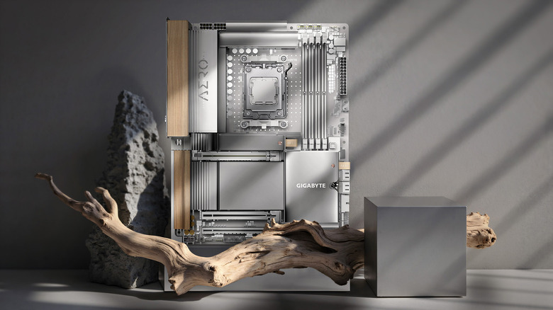A Gigabyte motherboard with wood trim on a gray table