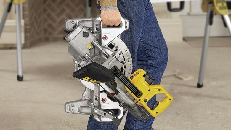Man holding a miter saw