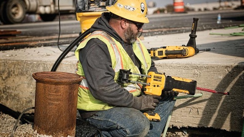 Construction worker applying adhesive using the caulking gun