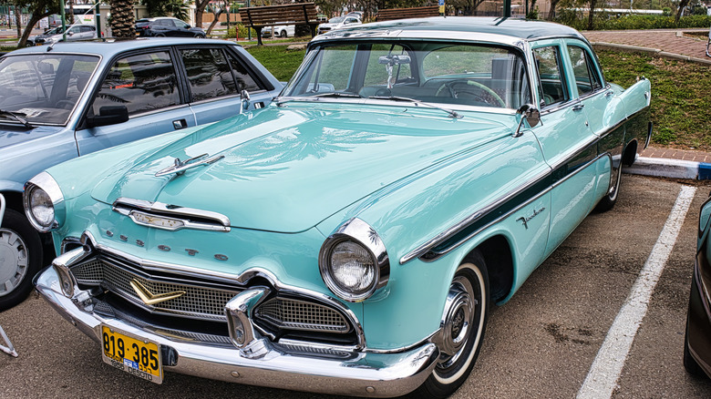 Green De Soto firelight parked in parking lot.