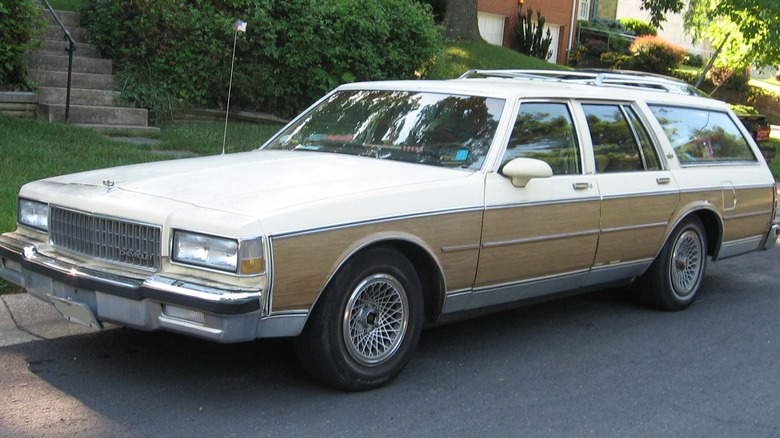 Chevy Caprice station wagon from the late 1980s, parked on a nondescript sidewalk in the USA