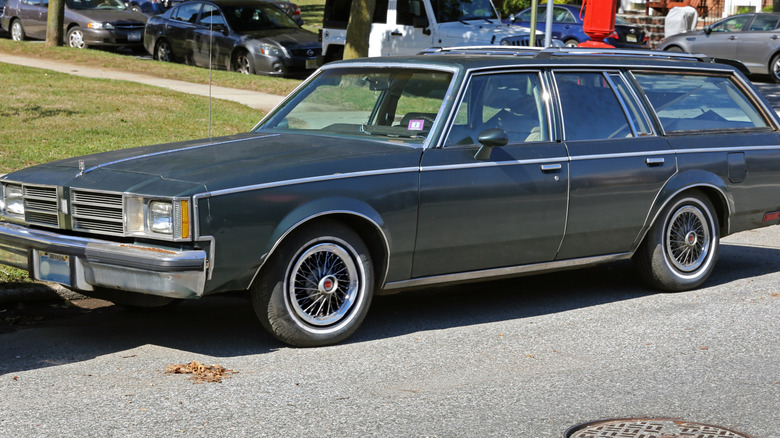 1981 Oldsmobile Cutlass Cruiser station wagon parked on the side of a suburban road