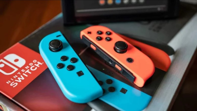 Nintendo Switch Joy-Cons sitting on top of a retail box 